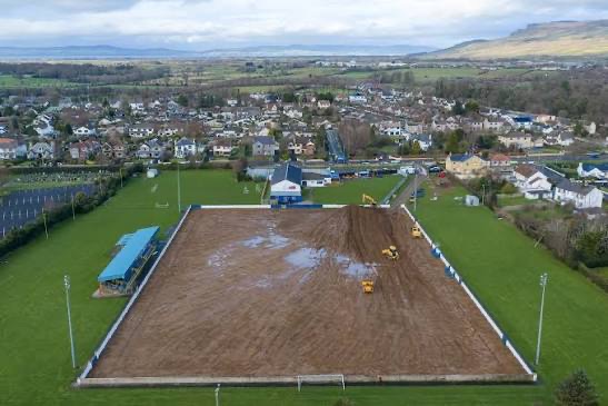 Machinery grading and shaping the base layer of the new pitch